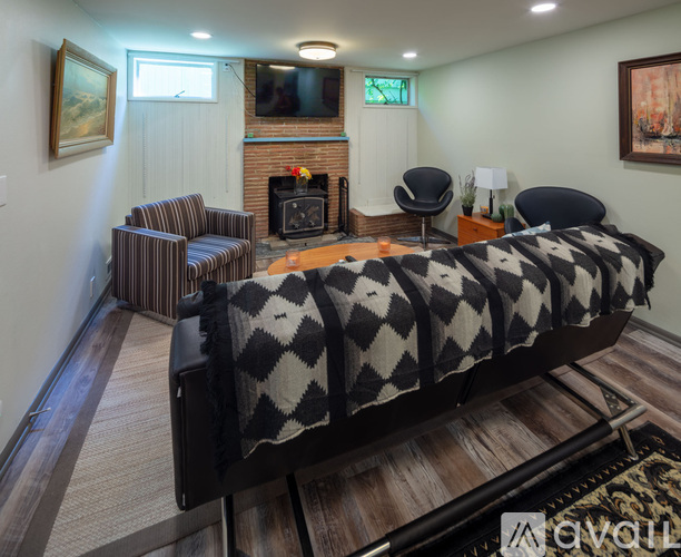 A bedroom with a large bed and a fireplace.