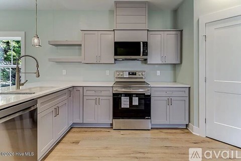 A kitchen with a stove top oven and a microwave above it.