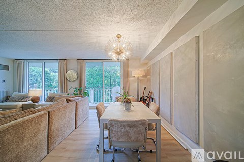 A dining room with a table and chairs.
