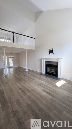 A living room with a fireplace and a balcony.