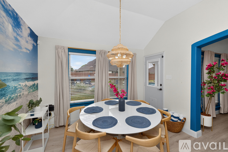 A dining room with a round table and chairs.