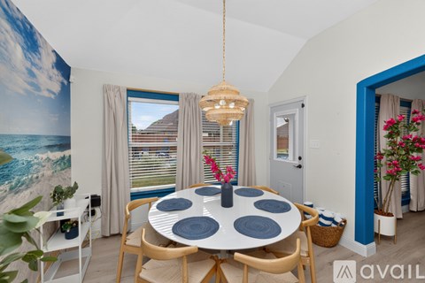 A dining room with a round table and chairs.