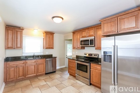 A kitchen with wooden cabinets and stainless steel appliances.
