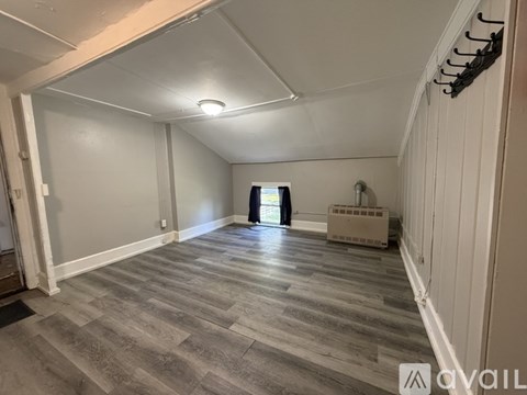 A room with a grey floor and white walls.