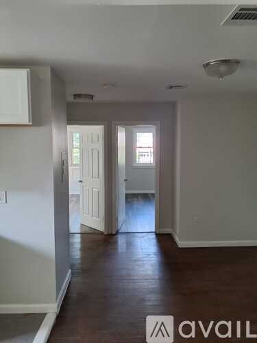 A room with wooden floors and white walls.