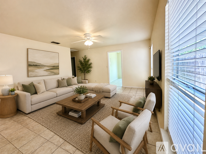 A living room with a couch, chairs, and a painting on the wall.