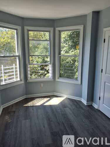 A room with grey walls and a wooden floor.