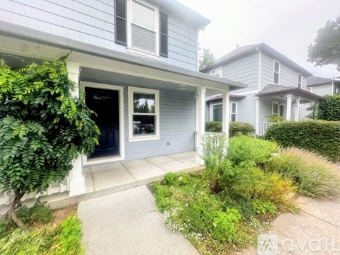 A house with a grey exterior and a white door.