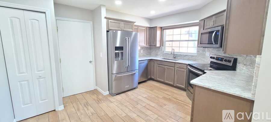 A kitchen with a refrigerator, stove, and oven.