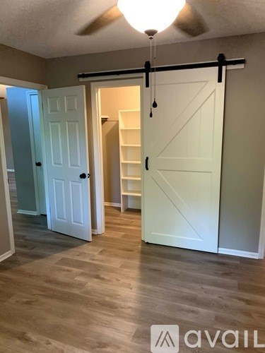 A room with a sliding door and a white door.