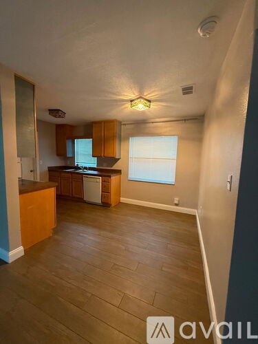 A kitchen with wooden cabinets and a refrigerator.