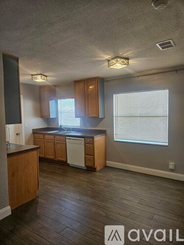 A kitchen with wooden cabinets and a dishwasher.