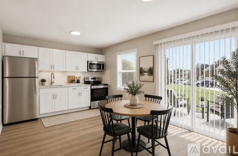 A kitchen with a table and chairs in front of a window.