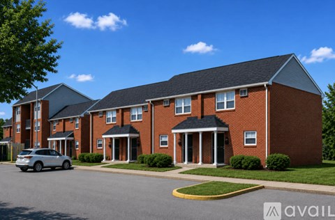 A modern brick apartment building with a car parked in front.