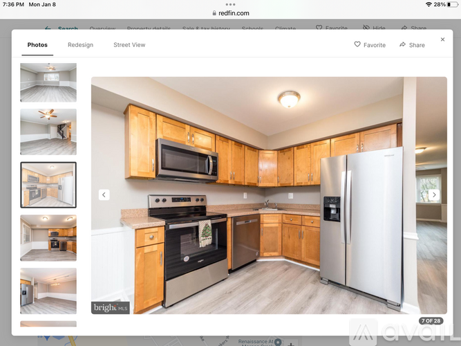 A kitchen with wooden cabinets and a white refrigerator.