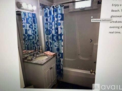 A bathroom with a sink, mirror, and shower.