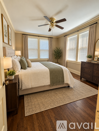 A bedroom with a bed, nightstand, and a ceiling fan.