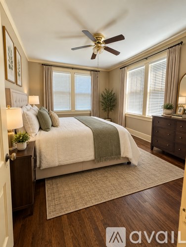 A bedroom with a bed, nightstand, and a ceiling fan.
