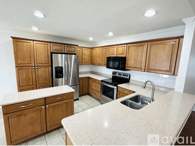 A kitchen with wooden cabinets and a granite countertop.