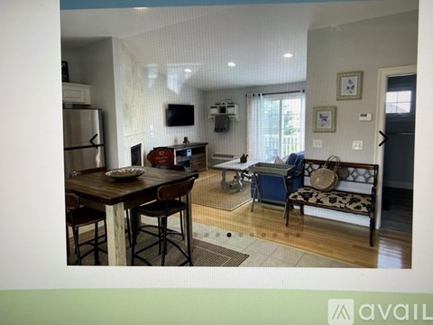 A kitchen with a dining table and chairs.