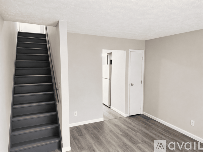 A room with a staircase leading to the upper floor.
