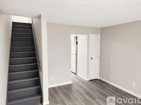 A room with a staircase leading to the upper floor.