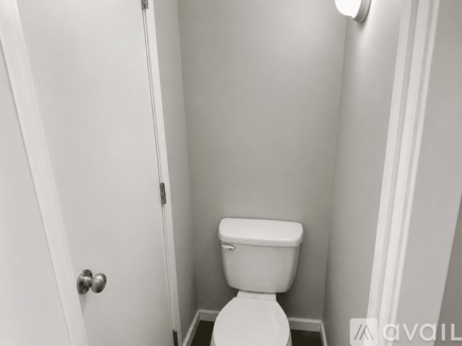 A white toilet in a small bathroom.
