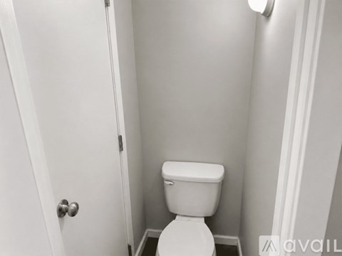 A white toilet in a small bathroom.