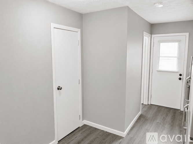 A white door is on the left and a white door with a window is on the right.