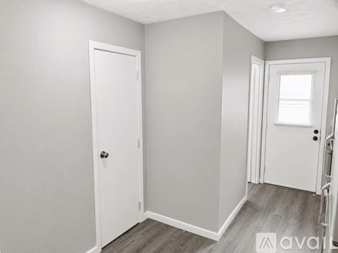 A white door is on the left and a white door with a window is on the right.