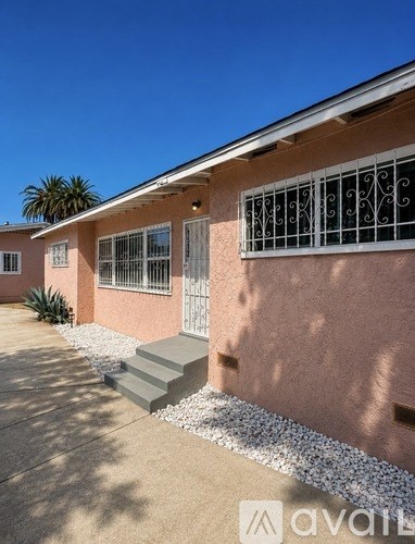 A house with a pink exterior and a white door.