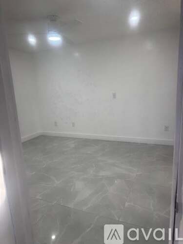 A room with a marble floor and white walls.
