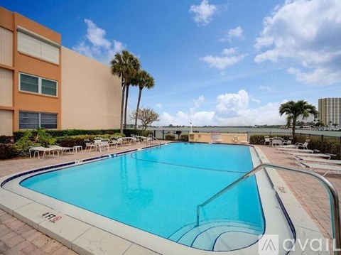 A large outdoor swimming pool with a clear blue sky above.