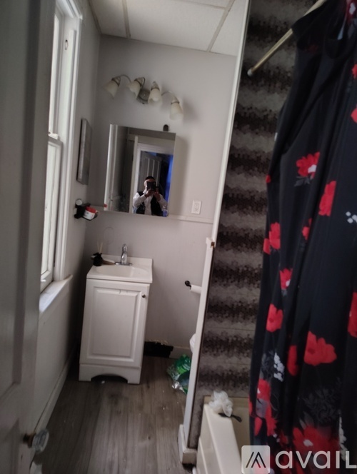 A bathroom with a white sink and a mirror.