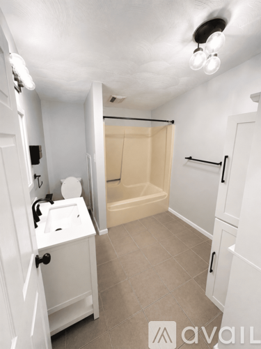 A small white bathroom with a toilet, sink, and bathtub.