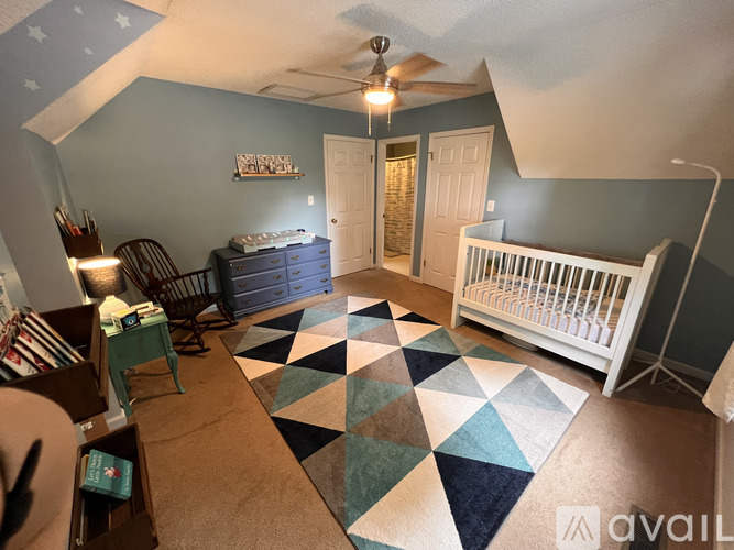 A baby room with a crib and a dresser.