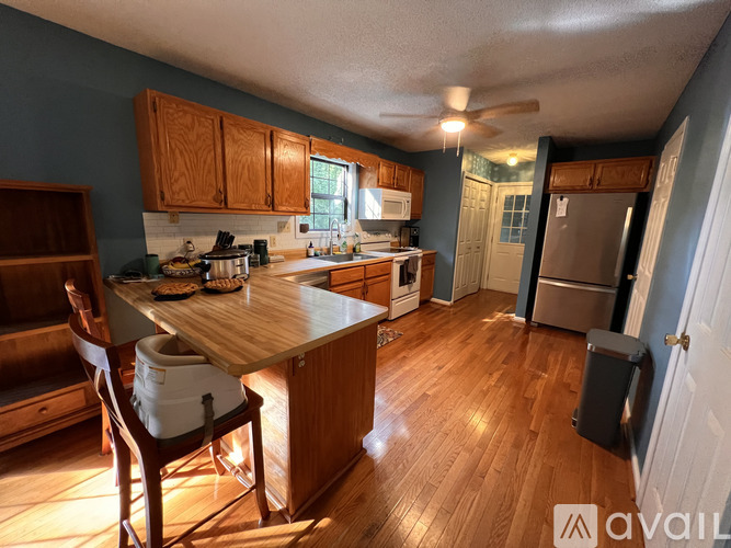 A kitchen with wooden cabinets and a wooden table with chairs.