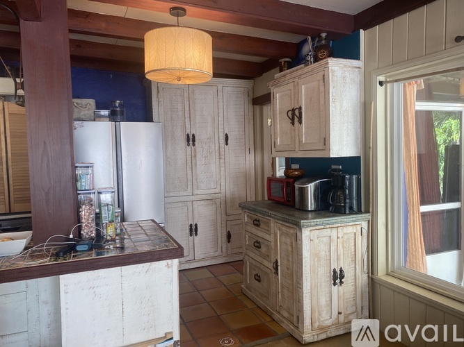 A kitchen with wooden cabinets and a white refrigerator.