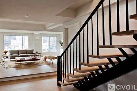 A living room with a staircase leading to the upper floor.