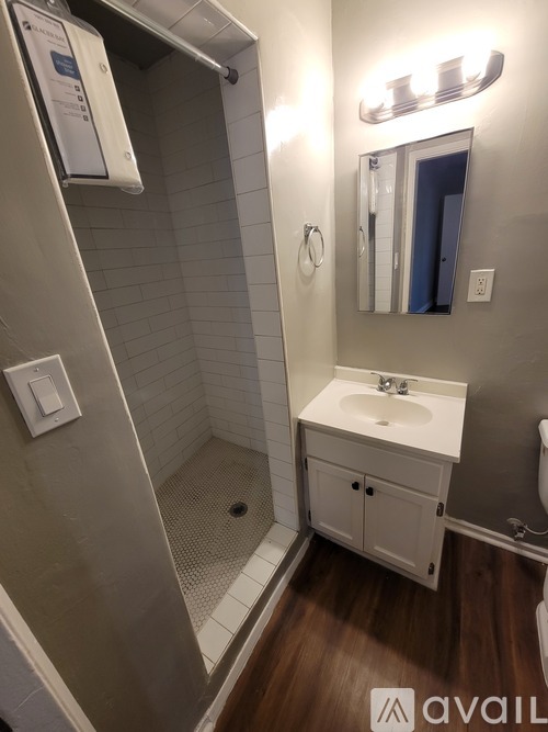 A bathroom with a white sink and a mirror above it.