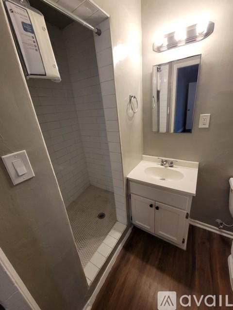 A bathroom with a white sink and a mirror above it.