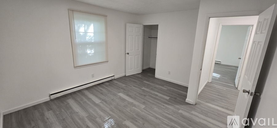 A room with a grey floor and white walls.