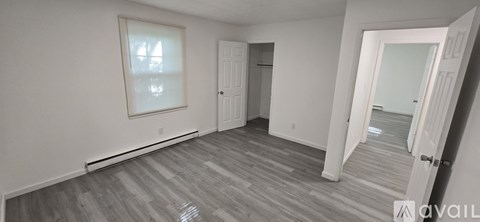 A room with a grey floor and white walls.