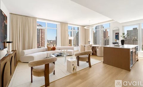 A living room with a white couch and a wooden floor.