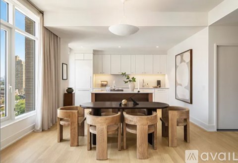 A dining room with a table and chairs.