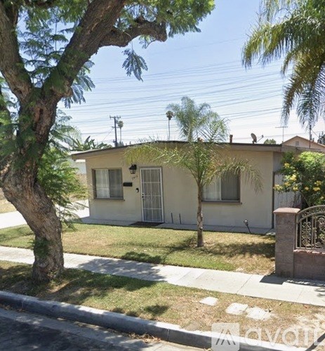 A house with a tree in front of it.
