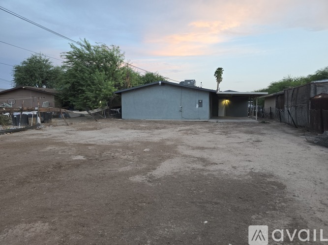 A large, open, and empty lot with a building in the background.