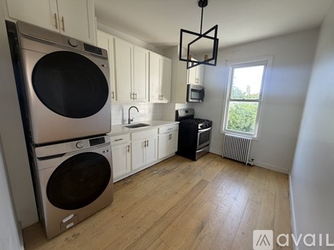 A kitchen with a washing machine and a dishwasher.