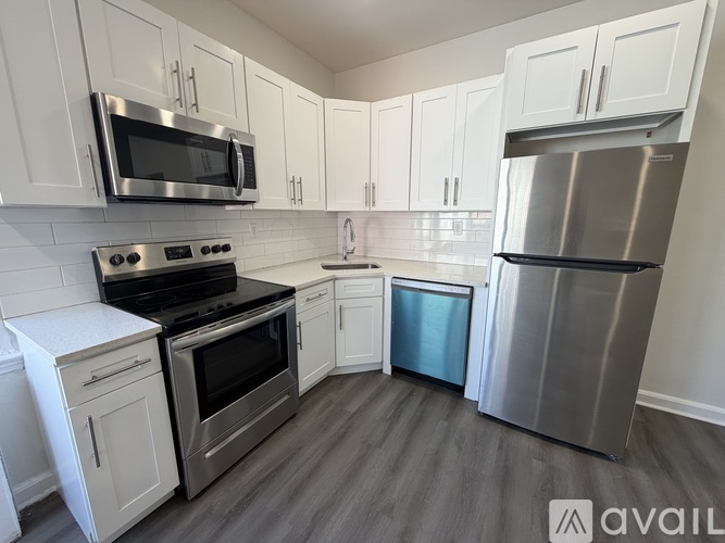 A kitchen with white cabinets and stainless steel appliances.