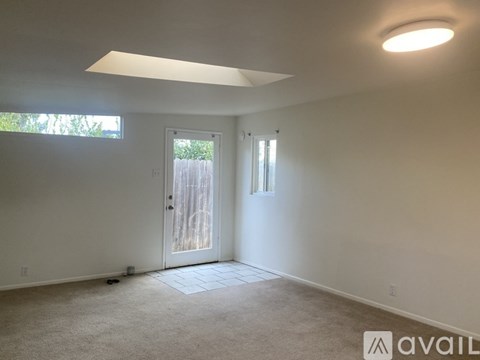 A room with a door and a window.